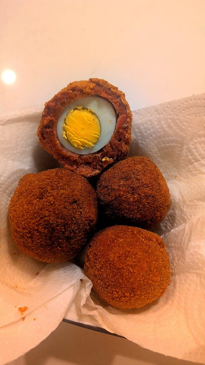 Crispy Nigerian-style beef scotch egg wrapped in seasoned beef sausage meat from Yetty Pastries Canada