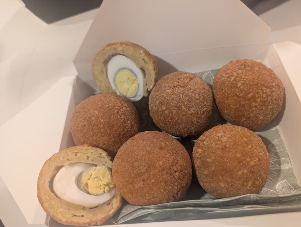 Golden crispy chicken scotch egg wrapped in seasoned chicken sausage meat from Yetty Pastries Canada